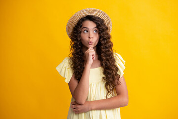 Teenager girl 12, 13, 14 years old thinking against yellow background. Child think and creative idea concept. Thinking teenager girl, thoughtful emotion.