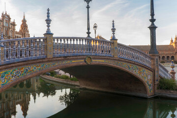 Andalusian ceramic bridge in canal with architectural background in Seville Andalusia Spain square Europe 
