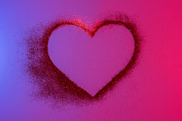 Heart of red bright sparkles in neon light. Shiny heart on a shiny background. Artistic design colorful and shiny bright background for holidays.