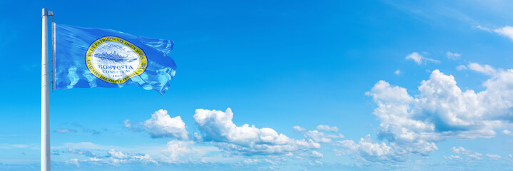 Obraz na płótnie Canvas Boston - USA, flag waving on a blue sky in beautiful clouds - Horizontal banner