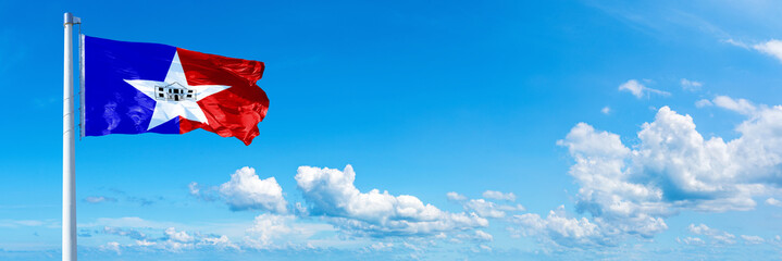 San Antonio - USA, flag waving on a blue sky in beautiful clouds - Horizontal banner