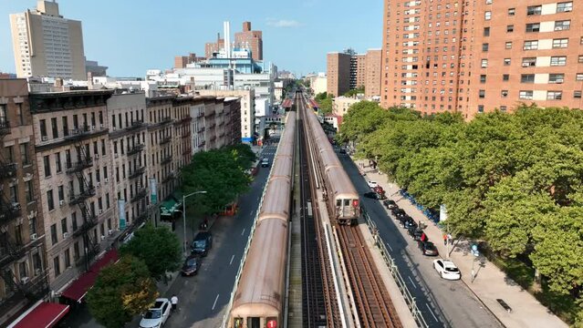 two 1 trains crossing paths on elevated subway track in Harlem New York City NYC