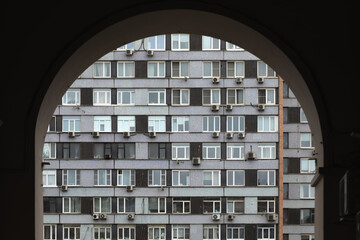 View through the arch at the facade of the building.