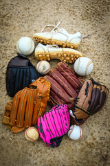 Close-up of Baseball Equipment including baseball gloves, balls, cleats and bats at park in Central...
