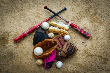 Close-up of Baseball Equipment including baseball gloves, balls, cleats and bats at park in Central...