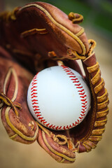 Close-up of Baseball Equipment including baseball glove and baseball at park in Central Florida