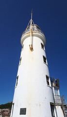 Naklejka premium the historic harbour lighthouse in scarborough yorkshire against a blue summer sky