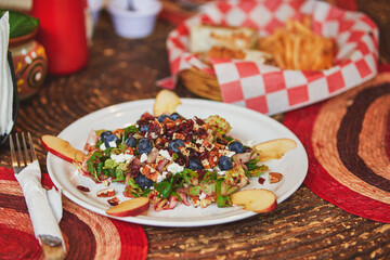 Restaurant fast food. Red fruit salad with lettuce, apple, cheese, almonds, blueberry, food with friends, eating on the go.