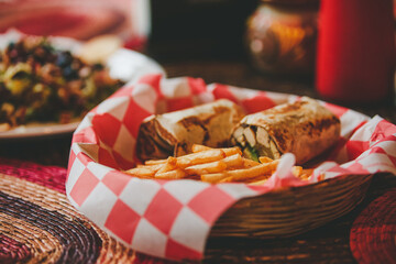 Restaurant fast food. Chicken, cheese, and avocado burrito with fries