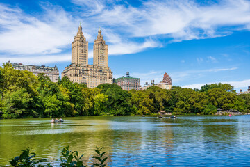 The Lake in Central Park with row boats and The San Remo hotel in the background, upper Manhattan,...