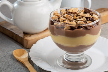 Dessert in the glass. Pastry cream dessert with chocolate ganache.