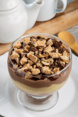 Dessert in the glass. Pastry cream dessert with chocolate ganache.