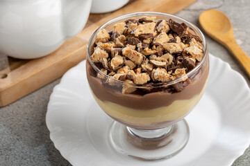 Dessert in the glass. Pastry cream dessert with chocolate ganache.
