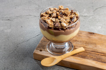 Dessert in the glass. Pastry cream dessert with chocolate ganache.