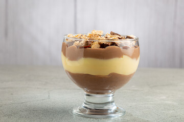 Dessert in the glass. Pastry cream dessert with chocolate ganache.