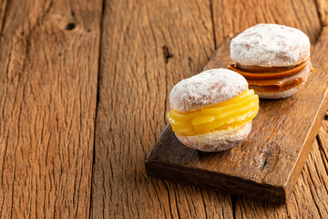 Berlin balls. Bread filled with pastry cream and topped with sprinkled sugar.