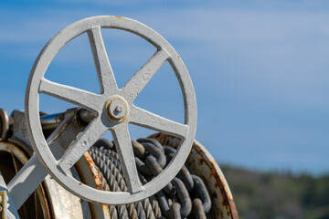 Hand wheel with anchor chain and cable.