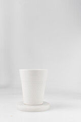 white ceramic cup on a white marble saucer, white teacup