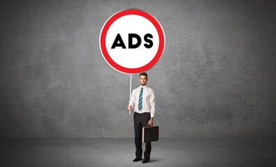 Young business person holdig traffic sign