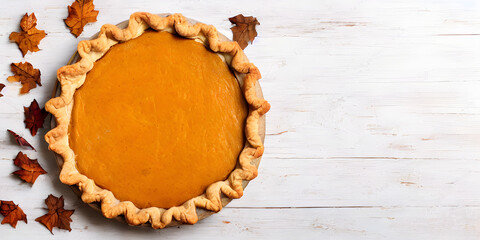 Pumpkin pie on a white wooden board