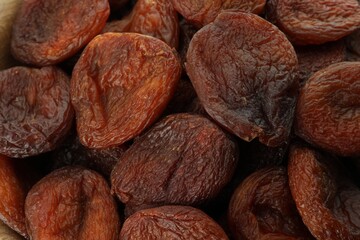 Tasty dried apricots as background, top view