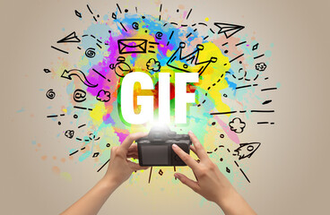 Close-up of a hand holding digital camera with abstract drawing
