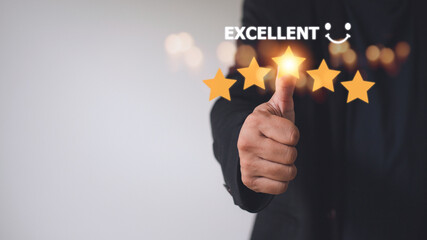 customer hand  with gold five star rating feedback icon and press level excellent rank for giving best score point to review the service, business concept