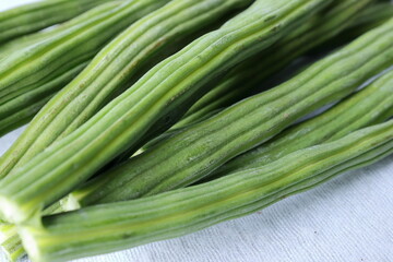 Drumstick Vegetable or Moringa on display in white background 
