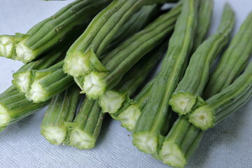 Drumstick Vegetable or Moringa on display in white background 