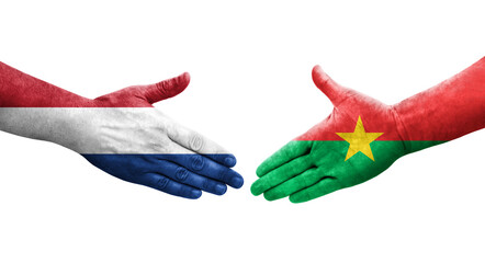 Handshake between Burkina Faso and Netherlands flags painted on hands, isolated transparent image.