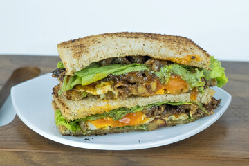 Sandwich on a cutting board. Pieces of appetizing of shortplate beef.