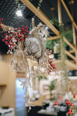 Christmas decration ornamental for family restaurant. Combined artificial red flower, tree and plants. Seasonal decoration. Starry light tree. 