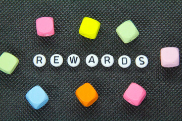 small white circle with the word rewards on a dark background. winning concept