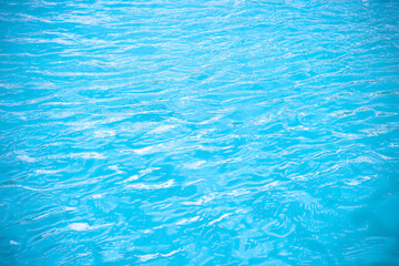Fototapeta na wymiar Summer water ripple in swimming pool abstract blue background