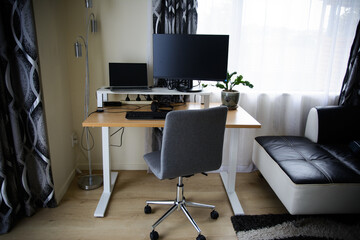 Home office with computer, desk and a chair
