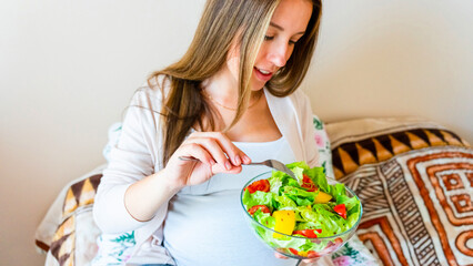 Obraz na płótnie Canvas Pregnancy eating healthy salad. Happy pregnant woman eating nutrition food. People lifestyle food concept.