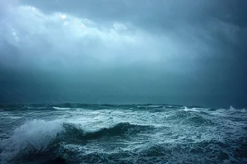 Schilderijen op glas sea wave during storm in the ocean with big clouds and rain. © Youk