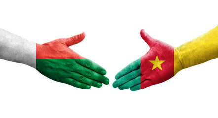 Handshake between Cameroon and Madagascar flags painted on hands, isolated transparent image.