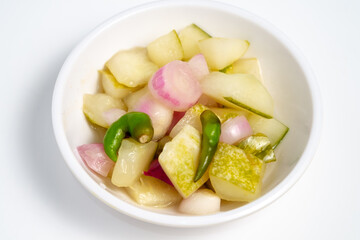Typical Indonesian cucumber pickle, usually cucumber cut into squares with the addition of shallots and whole cayenne pepper
