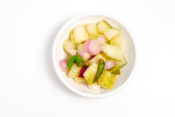 Typical Indonesian cucumber pickle, usually cucumber cut into squares with the addition of shallots and whole cayenne pepper
