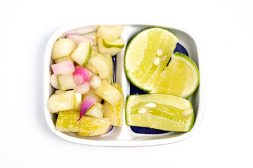 Typical Indonesian cucumber pickle, usually cucumber cut into squares with the addition of shallots and whole cayenne pepper
