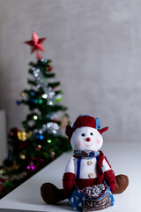 portrait of stuffed snowman with Christmas lights with space for text