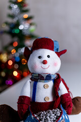 cute stuffed snowman portrait with Christmas lights with space for text