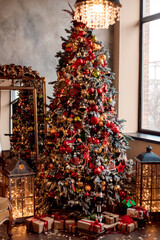 Large Christmas tree with red balls near the retro mirror