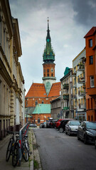 Neo-gothic church visible through narrow old town street