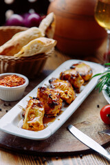 Grilled chicken kebab in a restaurant. Beautiful restaurant serving dishes, barbecue on a skewer.