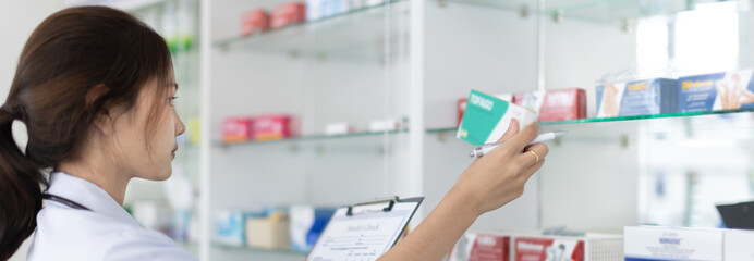 Pharmacist women are supplying prescription drugs to customers, Pharmacists work in a pharmacy, Drug store shelf with prescription medication, Clipboard at the hospital pharmacy, Community Pharmacy.