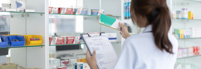 Pharmacist women are supplying prescription drugs to customers, Pharmacists work in a pharmacy,...