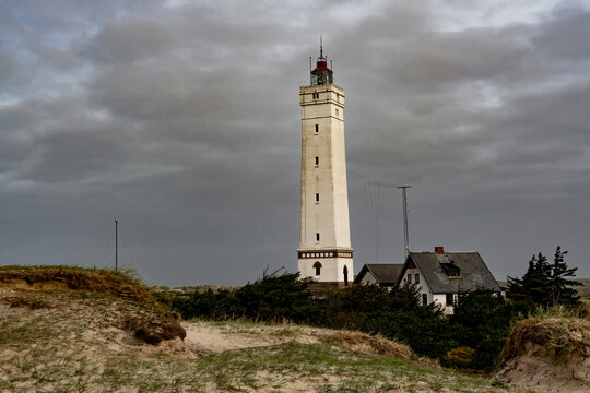 Bl&aring;vandshuk Lighthouse at the westernmost point on Denmark under a dramatic autumn sky