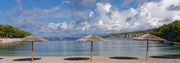 Life is better at the beach, beautiful beach on the Croatian Mediterranean coast with three reed...